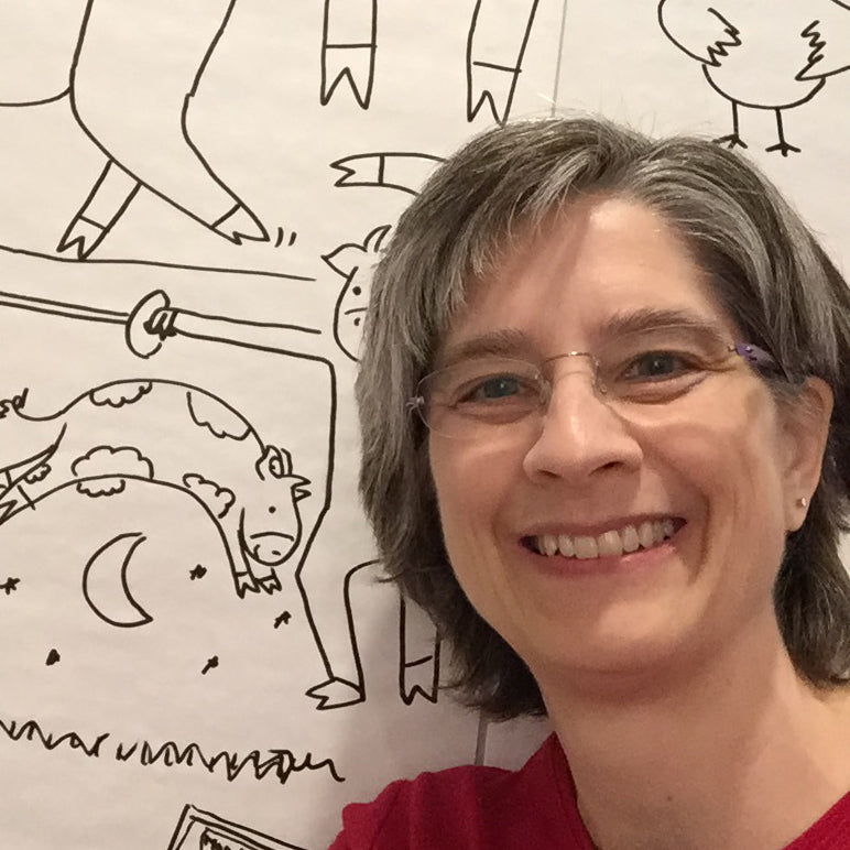 artist (white woman wearing glasses and a red shirt, with short brown and grey hair) in front of her drawings of cows